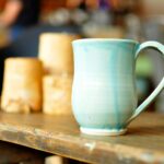 focused photo of a blue ceramic mug