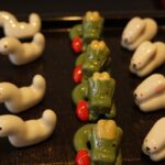 a row of toy animals sitting on top of a table